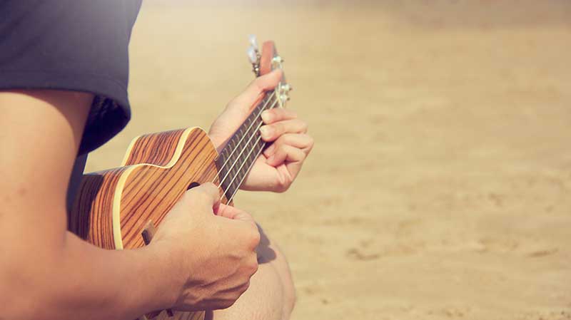 play the ukulele
